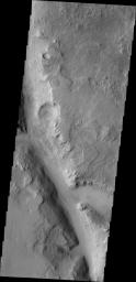 This image taken by NASA's 2001 Mars Odyssey shows just one of the many channels located in the northern part of Terra Sabaea which is heavily fractured and channeled, breaking up into a chaotic terrain as the elevation drops down to the northern plains. 