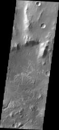 NASA's 2001 Mars Odyssey captured this image of a channel entering  Eberswalde Crater and depositing a fan-shaped delta on the crater  floor.