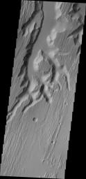 This image from NASA's 2001 Mars Odyssey shows a small portion of the complex channel system, Kasei Valles. In this image, secondary channeling has cut down deeper into the main channel.