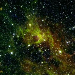This image from NASA's Spitzer Space Telescope shows a wispy, vast structure in the constellation Perseus with a small bubble right in its center puffed out by spasms of fresh-formed, heavyweight stars.