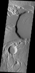 This image from NASA's Mars Odyssey shows part of the summit caldera of Ceraunius Tholus, one of the smaller volcanoes of the Tharsis region.