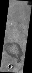 Located in Solis Planum, this unusual volcanic flow has margins darker than the surroundings. It appears that the flow originated in the linear fracture or vent that bisects the flow deposit. This image was captured by NASA's Mars Odyssey.