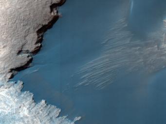 This image from NASA's Mars Reconnaissance Orbiter shows part of the floor of Rabe Crater, a large impact crater in the Southern highlands. Dark dunes cover part of crater's floor, and contrast with the surrounding bright-colored outcrops.