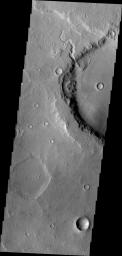 This unnamed crater in northern Terra Cimmeria has a small channel that created a delta feature. Such features are important indicators of liquid water in Mars' past as shown in this image from NASA's Mars Odyssey.
