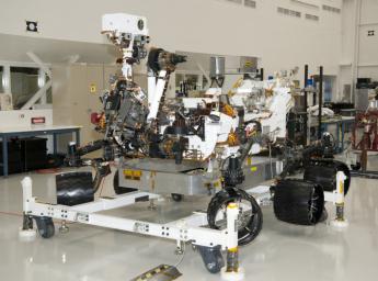 The rover for NASA's Mars Science Laboratory mission, named Curiosity, is seen here inside the Spacecraft Assembly Facility at NASA's Jet Propulsion Laboratory, Pasadena, Calif. Support equipment is holding the rover slightly off the floor.
