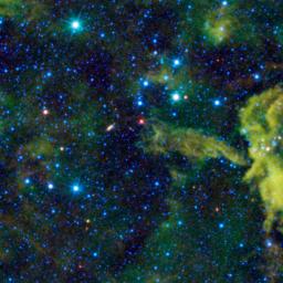 This stellar object is called Spitzer 073425.3-465409, as seen by NASA's Wide-field Infrared Survey Explorer; the cloud CG4 might be imagined as a cosmic alligator eating its way across the sky.