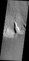 This image captured by NASA's 2001 Mars Odyssey shows lava flows in the southern escarpment region of Olympus Mons, the largest known volcano in the solar system.
