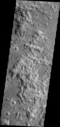 The eastern end of Valles Marineris opens into huge low lying channels filled with the mound and valley terrain called chaos. This image from NASA's 2001 Mars Odyssey shows part of Eos Chaos.