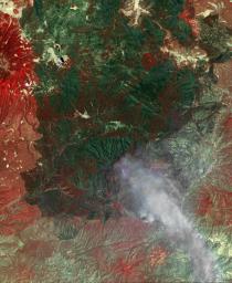 NASA's Terra spacecraft acquired this image of the Wallow fire in Arizona on June 21, 2011; vegetation appears in red, bare ground in shades of tan, burned areas in black and very-dark red; and smoke from the active fire front appears gray.