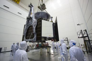 Technicians use an overhead crane to lower NASA's Juno spacecraft onto a fueling stand where the spacecraft will be loaded with the propellant necessary for its mission to Jupiter.