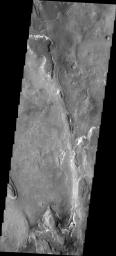 The layered ridge and mesas in this image from NASA's 2001 Mars Odyssey spacecraft are located on the northern margin of Hellas Basin.