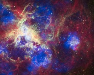 This composite of 30 Doradus, the Tarantula Nebula, contains data from Chandra (blue), Hubble (green), and Spitzer (red). Located in the Large Magellanic Cloud, the Tarantula Nebula is one of the largest star-forming regions close to the Milky Way.