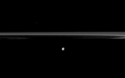 Saturn's moon Mimas joins the planet's rings which appear truncated by the planet's shadow in this image from NASA's Cassini spacecraft.