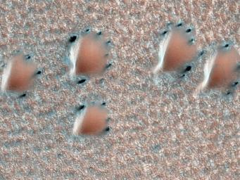 This image from NASA's Mars Reconnaissance Orbiter depicts a scene from early spring in the northern hemisphere of Mars. These dunes are covered with a layer of seasonal carbon dioxide ice (dry ice).