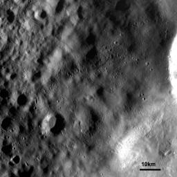 This image from NASA's Dawn spacecraft shows an ejecta blanket mantling the surface and obscuring older caters. The bright crater rim, seen in the middle right edge, is one of a group of craters which are the source of this ejecta blanket.