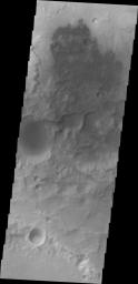Small dunes are located on the floor of this unnamed crater in Terra Cimmeria as seen by NASA's 2001 Mars Odyssey spacecraft.