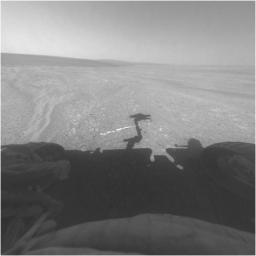 This view from the front hazard-avoidance camera on NASA's Mars Exploration Rover Opportunity shows the rover's arm's shadow falling near a bright mineral vein informally named 'Homestake.'