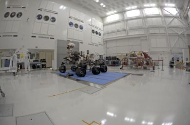 Right-eye view of NASA's Curiosity rover and its powered descent vehicle pose for photographs prior to being integrated for launch at JPL's Spacecraft Assembly Facility.