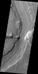 This image captured by NASA's 2001 Mars Odyssey spacecraft shows Reull Vallis where it cuts through the rim of Lipik Crater.