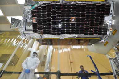 Inside an environmental enclosure at Vandenberg Air Force Base's processing facility in California, solar panels line the sides of NASA's Nuclear Spectroscopic Telescope Array (NuSTAR), which was just joined to the Orbital Sciences Pegasus XL rocket.