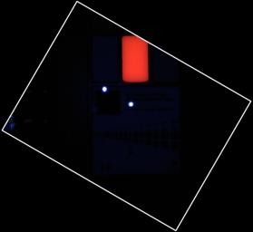 During pre-flight testing in March 2011, the Mars Hand Lens Imager (MAHLI) camera on NASA's Mars rover Curiosity took this image of the MAHLI calibration target under illumination from MAHLI's two ultraviolet LEDs (light emitting diodes).