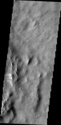 Dark streaks mark the inner rim of this unnamed crater in Terra Sabaea as seen by NASA's 2001 Mars Odyssey spacecraft.