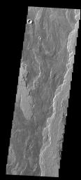 The lava flows seen in this image from NASA's 2001 Mars Odyssey spacecraft are part of Daedalia Planum. The flows are associated with Arsia Mons.