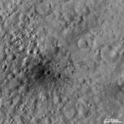 This image from NASA's Dawn spacecraft shows Aricia Tholus, a dark hill located in asteroid Vesta's Marcia quadrangle. Tholus is a word used to describe a small dome-like mountain or hill. Aricia was the name of a city in ancient Italy.