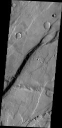 The cliff face in this image from NASA's 2001 Mars Odyssey spacecraft was created by tectonic activity and is located in a region of Tempe Terra that is complexly fractured.