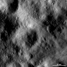 This image of asteroid Vesta from NASA's Dawn spacecraft shows an area of the surface that is both grooved and smooth, which gives it an undulating appearance. This image is located in Vesta's Numisia quadrangle, near the Vestan equator.