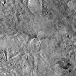 This image from NASA's Dawn spacecraft of asteroid Vesta shows Helena crater, which is the crater that resembles the shape of a butterfly's wings (center), and Laelia crater (bottom right).