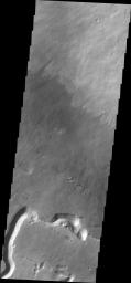 This image captured by NASA's 2001 Mars Odyssey spacecraft shows part of the southern flank of Pavonis Mons. Visible at the bottom of the image are collapse features and lava channels.