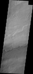 The volcanic flows in image from NASA's 2001 Mars Odyssey spacecraft are located south of Ascraeus Mons and east of Pavonis Mons.