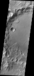 Landslide deposits cover part of the floor of this unnamed crater in Tyrrhena Terra as seen by NASA's 2001 Mars Odyssey spacecraft.