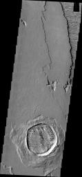 The crater in this image captured by NASA's 2001 Mars Odyssey spacecraft has not only been filled by wind-blown material, but that material has been eroded into the two directions of winnowing by continued wind action.