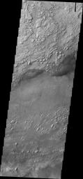This image from NASA's 2001 Mars Odyssey spacecraft shows a portion of the floor of Crommelin Crater. This crater contains a large mound of material that filled a large part of the crater and has been subsequently eroded.