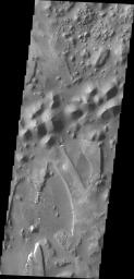 The unusual and apparently layered surface in this image from NASA's 2001 Mars Odyssey spacecraft is located in Aureum Chaos.