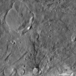 This image from NASA's Dawn spacecraft of asteroid Vesta shows Urbinia and Sossia craters, located in Vesta's Urbinia quadrangle. Urbinia is the large crater, and Sossia is the small crater surrounded by dark material in the bottom of the image.