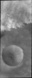 This image from NASA's 2001 Mars Odyssey captures storm clouds that are moving towards the crater in the bottom of this image. Storms like this are common during the spring and early summer near Mars' north pole.