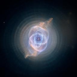 This detailed view of NGC 6543, the Cat's Eye Nebula, from NASA's Hubble Space Telescope includes intricate structures, including concentric gas shells, jets of high-speed gas, and unusual shock-induced knots of gas.