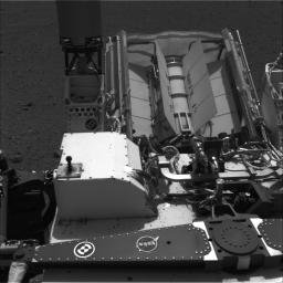 This image shows the calibration target for the Chemistry and Camera (ChemCam) instrument on NASA's Curiosity rover. The calibration target is one square and a group of nine circles that look dark in the black-and-white image.