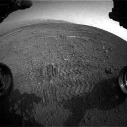This image taken by a front Hazard-Avoidance camera on NASA's Curiosity shows track marks from the rover's first Martian drives.