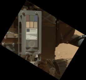 This view of the calibration target for the MAHLI camera aboard NASA's Mars rover Curiosity combines two images taken by that camera during Sept. 9, 2012. Part of Curiosity's left-front and center wheels and a patch of Martian ground are also visible.