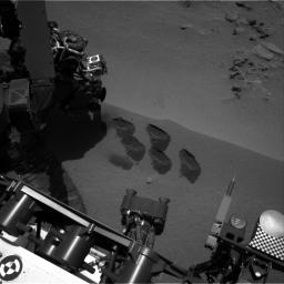 NASA's Mars rover Curiosity used a mechanism on its robotic arm to dig up five scoopfuls of material from a patch of dusty sand called 'Rocknest,' producing the five bite-mark pits visible in this image from the rover's left Navigation Camera (Navcam).