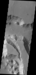 A very large valley (mega gully) on Mars cuts through part of this mesa in Chryse Chaos in this image as seen by NASA's 2001 Mars Odyssey spacecraft.