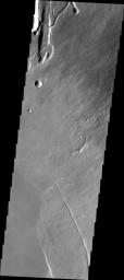 The lava channels and collapse features in this image from NASA's 2001 Mars Odyssey spacecraft are located near the summit of Arsia Mons. The fracture in the lower right part of the image marks the boundary of the summit caldera.