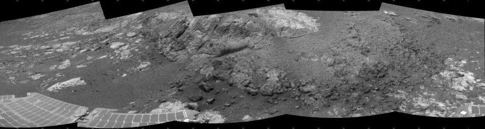 This 180-degree mosaic of images from the navigation camera on the NASA Mars Exploration Rover Opportunity shows the rover close to the outcrop called 'Copper Cliff,' which is in the center of this scene.