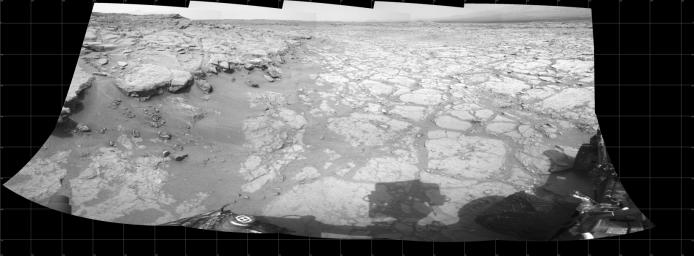 In a shallow depression called 'Yellowknife Bay,' the NASA Mars rover Curiosity drove to an edge of the feature to record this view of the ledge at the margin and a view across the 'bay' during the 130th Martian day, or sol, (Dec. 17, 2012).