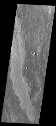 The lava flows in image from NASA's 2001 Mars Odyssey spacecraft are part of the vast flow field originating from Arsia Mons.