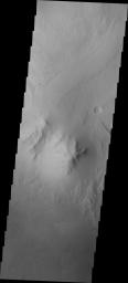 This image from NASA's Mars Odyssey spacecraft shows the highest elevation of layered deposit occurs at the top, but just south of the center of the image is a peak that does not appear to be layered and is eroding differently than the rest of Mt. Sharp.